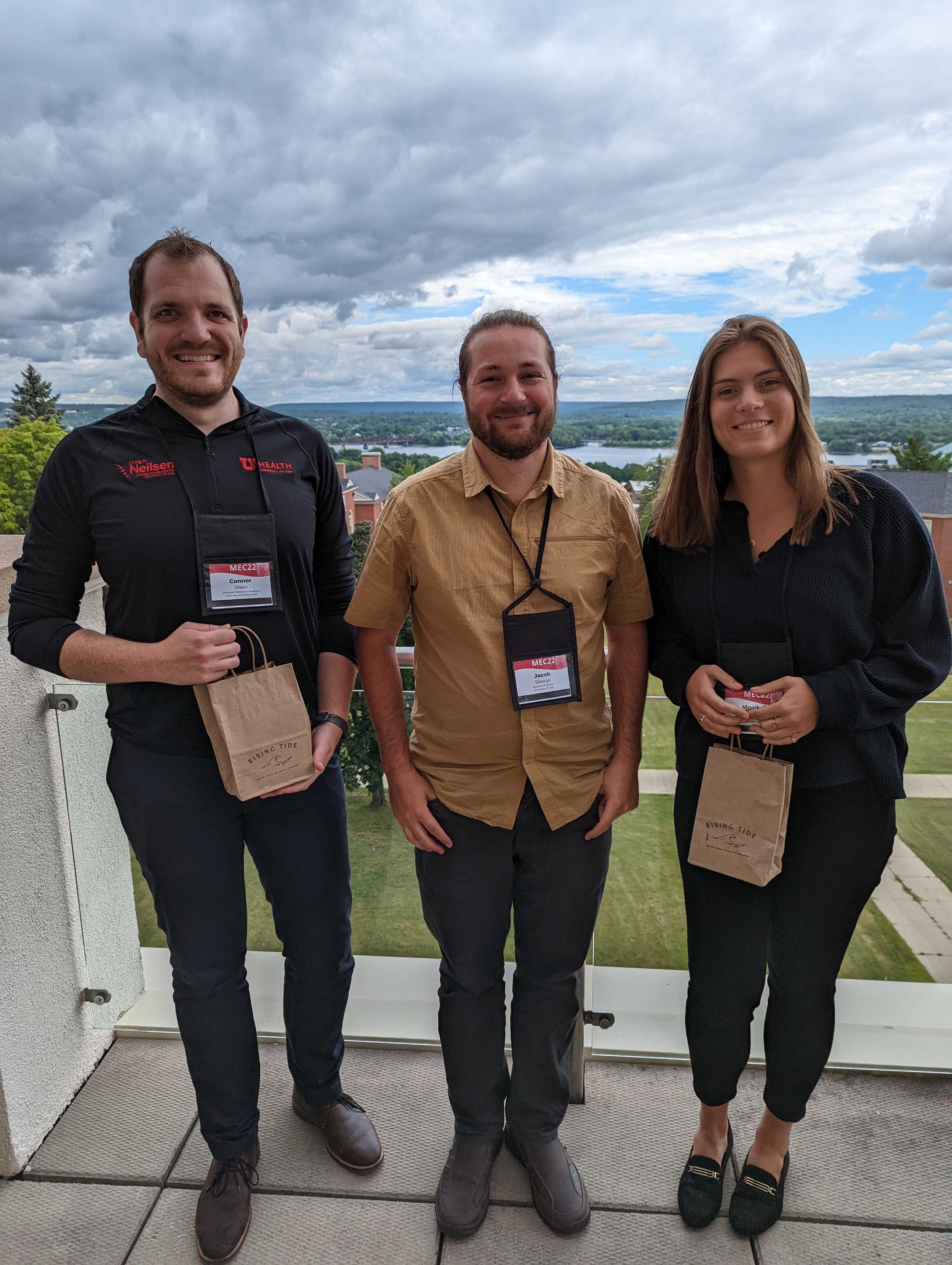 MEC 2022 Student Podium Presentation Competition award winners: Connor Olsen (Left) First Place, and Monika Buczak (right) second place, with their professor Jacob A. George in the center